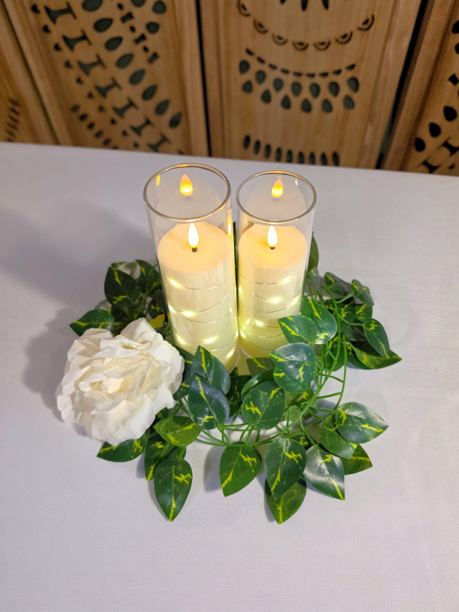 LED candle and ivy centerpiece viewed from above in a table setup