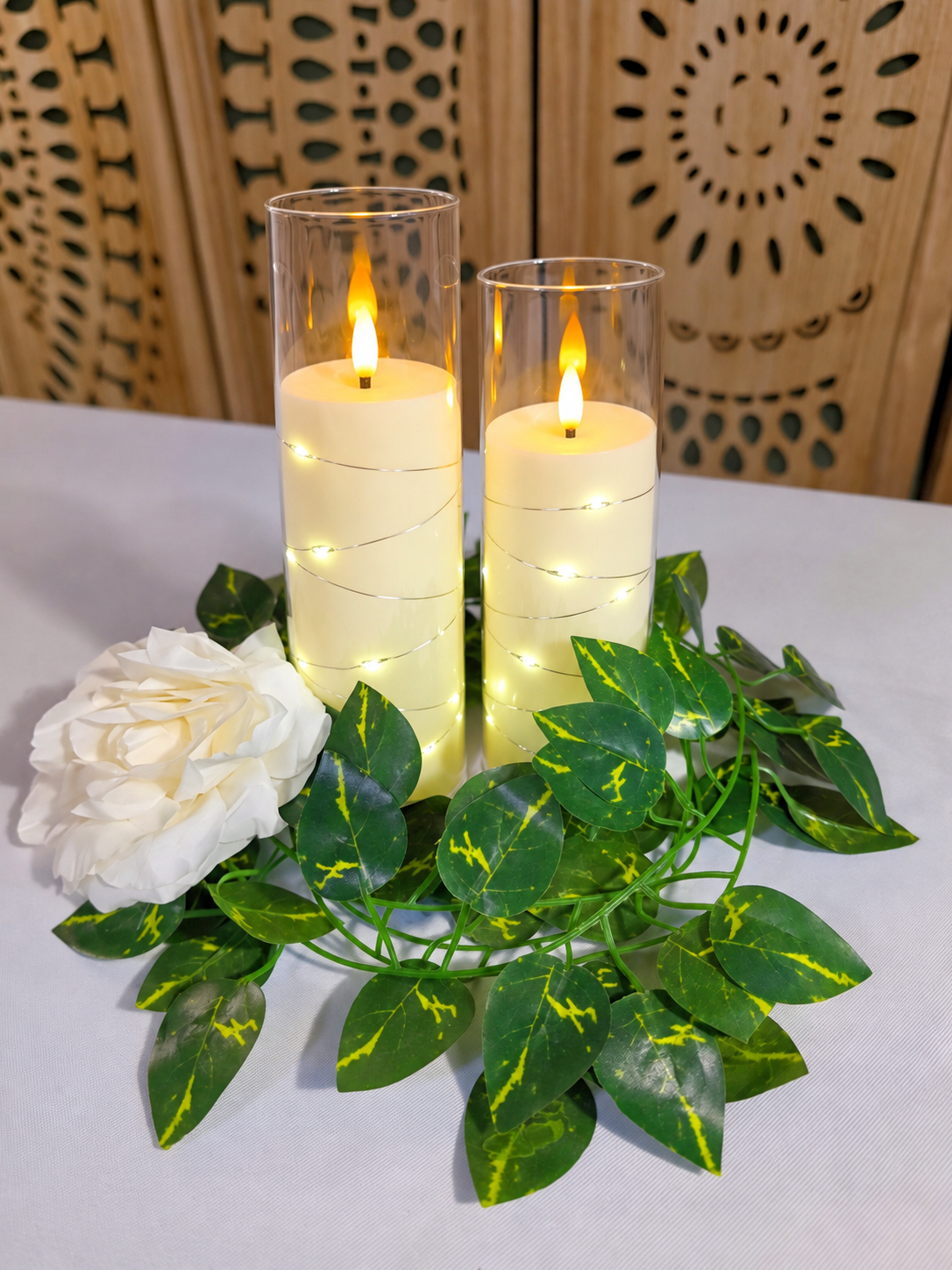 LED candle and ivy centerpiece shown in an event setup