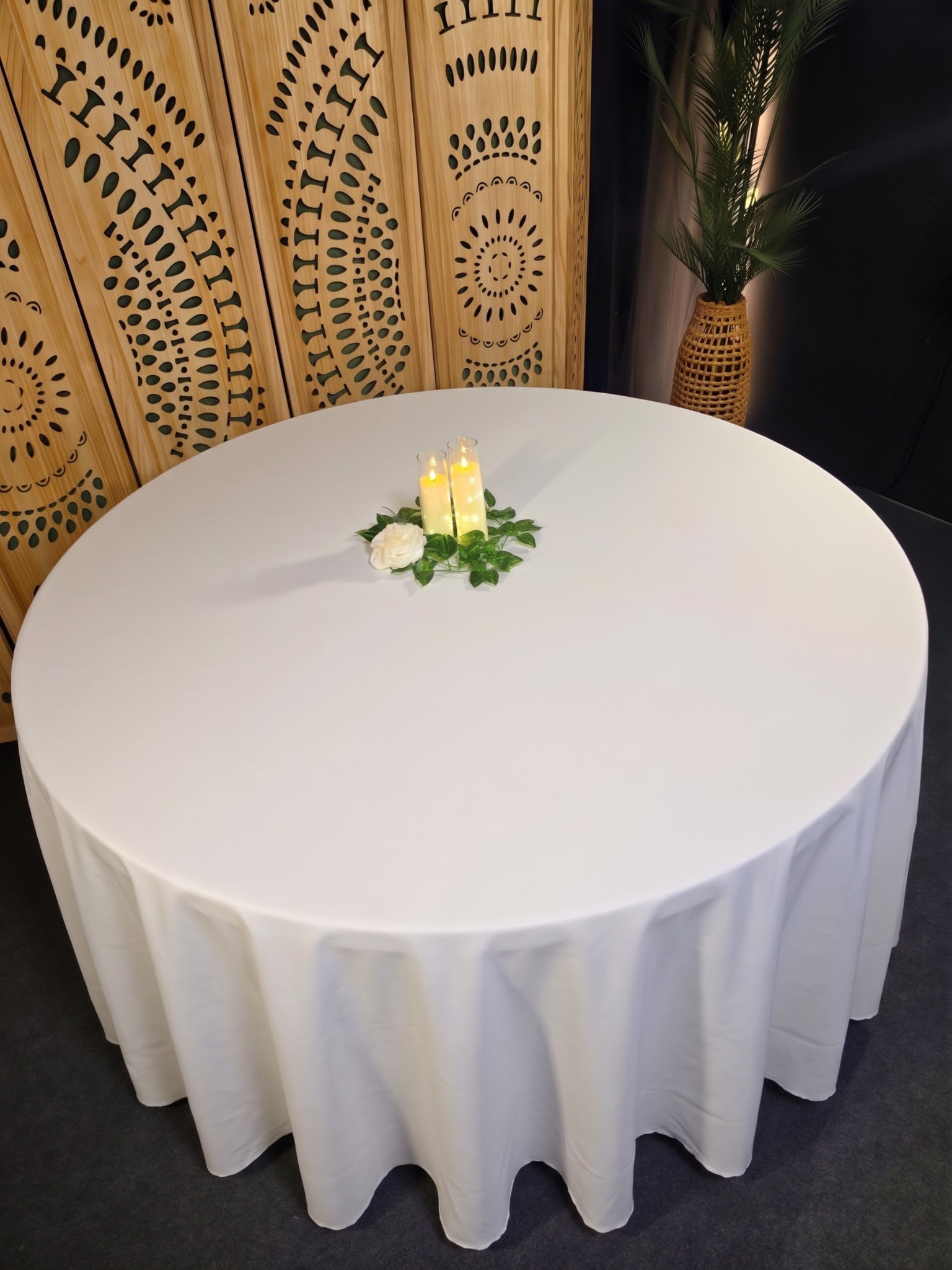 White round linen styled with an LED candle centerpiece